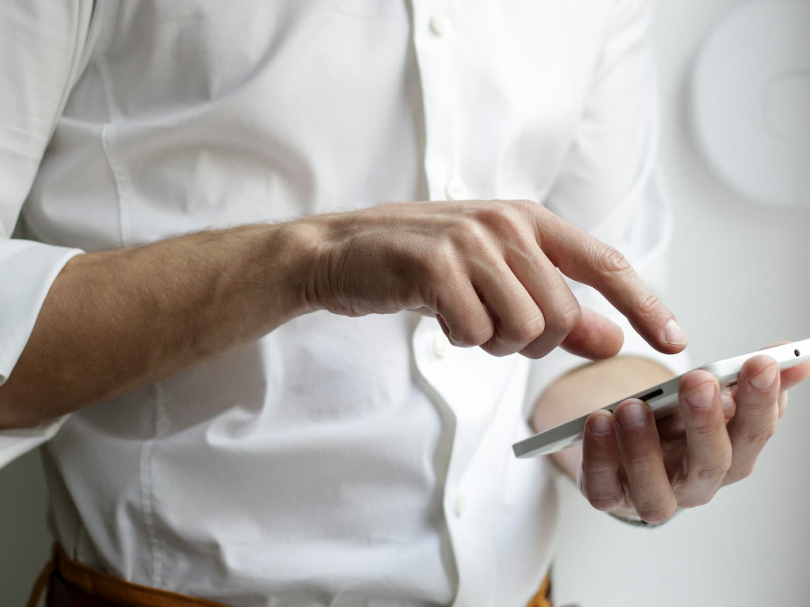 A person holding a phone in soft indoor light